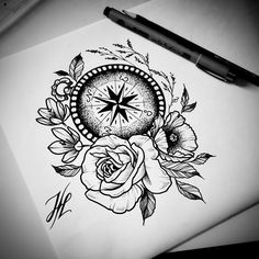 a drawing of a compass and roses on paper