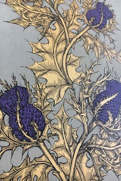 an image of blue thistles and leaves on a gray background with gold foiling