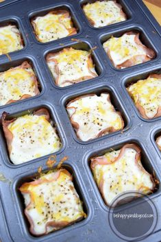 an open muffin tin filled with eggs and ham