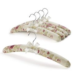 three flowered hangers with bows on them