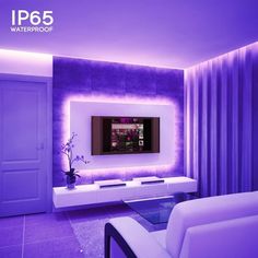 a living room with purple walls and white couches in front of a flat screen tv mounted on the wall