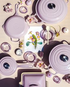 purple dishes and utensils laid out on a table