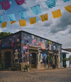 there is a building that has been decorated with colorful banners