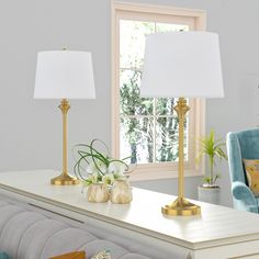 a living room scene with focus on the table lamp and chair, along with two lamps