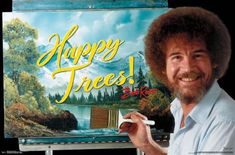 a man holding a paintbrush in front of a sign that says, happy trees