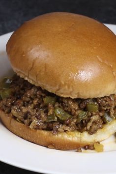 a sloppy joe sandwich on a white plate