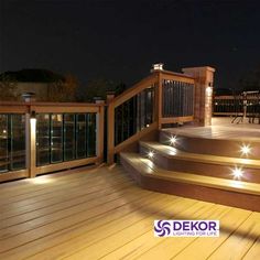 an outdoor deck lit up with lights at night