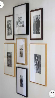 a wall with several pictures hanging on it's side and the bottom half is black and white