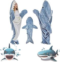 two people in shark costumes standing next to each other with sharks on their backs and one woman wearing a white dress