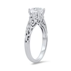 a white gold engagement ring with an intricate filigree design