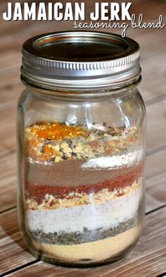 a jar filled with different types of food on top of a wooden table and text overlay that reads jamaican jerk seasoning blend