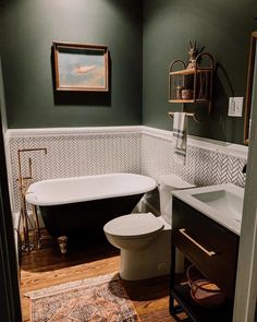 a bathroom with a tub, toilet and sink in it's centerpieces