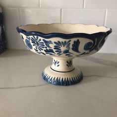 a blue and white bowl sitting on top of a counter