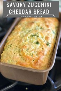 a loaf of savory zucchini cheddar bread in a baking pan