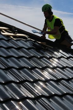 a man working on the roof of a building