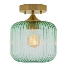 a green glass light fixture with a gold metal frame and an open bulb on the top