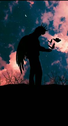 the silhouette of a man with wings in front of a sky filled with stars and clouds