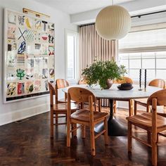 a dining room with wooden chairs and a white table