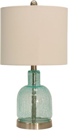 a green glass table lamp with a white shade