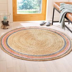 a round rug on the floor in front of a window