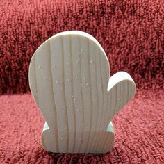 a small wooden object sitting on top of a red blanket