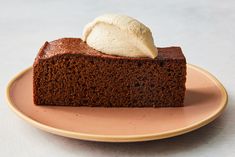 a piece of chocolate cake on a plate with a scoop of ice cream in the middle