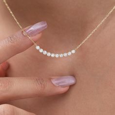 Elevate your style with our dainty 14k Curved Bar Diamond Necklace. This minimalist and handcrafted piece features a delicate bar pendant adorned with sparkling diamonds, making it the perfect wedding gift for her. Embrace the elegance and timeless beauty of this handmade diamond jewelry. Order now and make a statement of sophistication! Alternatively, choose from our options of natural, lab-grown diamonds or dazzling moissanites at three different price points to fit your unique preferences and budget. Please check below to see specifications of each stone option. All our pieces come with Azalea Certification and Warranty document.  Independent appraisals cost an additional $60. All pieces over $2,000 come with free appraisal. M A T E R I A L & L E N G T H Available in 14k Yellow Gold, 14 Diamond Necklace Pendant Ideas, 14k Gold Bar Necklace For Anniversary, Minimalist Diamond Necklace, Diamond Birthday, Dainty Bar Necklace, Necklace Bar, Curved Bar Necklace, Diamond Bar Necklace, Curved Bar