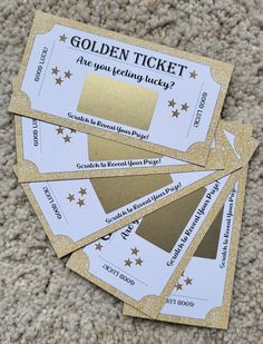 four golden ticket tickets sitting on top of carpet