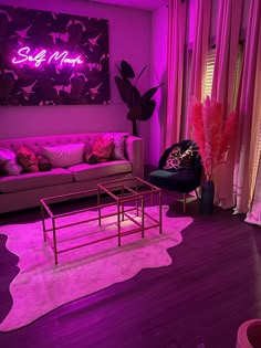 a living room filled with furniture and purple lighting