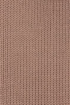 a close up view of the texture of a knitted sweater in light brown color