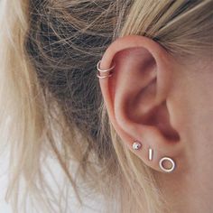 a close up of a person's ear with two piercings on the side