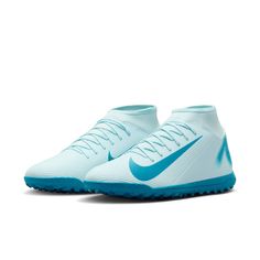 a pair of white and blue soccer shoes on a white background with the word nike written in