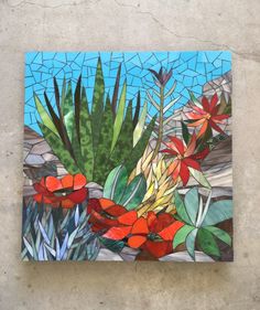 a painting on the ground with flowers and plants painted on it's glass panels