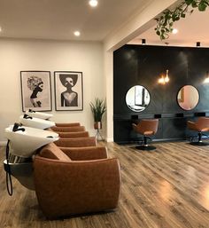 a salon with chairs, mirrors and pictures on the wall