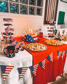 a table with american flags and desserts on it