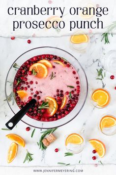 cranberry orange proseco punch in a glass bowl with garnish