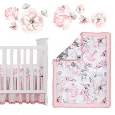 a crib bedding set with pink flowers on the wall and white crib