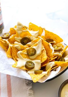 nachos with cheese and olives on a plate