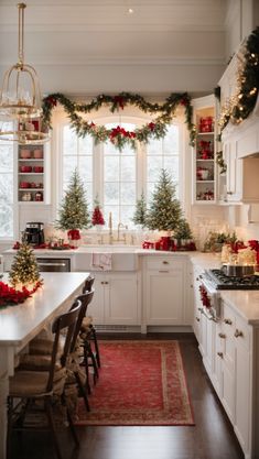 a kitchen decorated for christmas with red and green garlands on the window sill