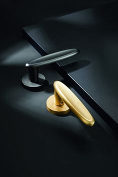 a black table with an oval handle and two round knobs