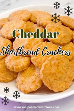 cheddar shortbread crackers on a plate with snowflakes in the background