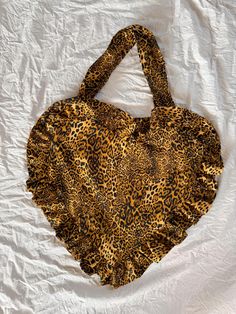 Unleash your wild side with our bold and trendy leopard print heart-shaped bag. Perfect for fashion-forward individuals, this unique accessory adds an edgy yet playful touch to any outfit. Crafted from high-quality materials, the statement-making leopard print pairs effortlessly with the heart shape to create a standout piece that's sure to turn heads. Whether you're going for a casual day out or dressing up for a night on the town, this versatile bag is the perfect way to elevate your look. Its Heart Shaped Bag, Heart Bag, Accessories Unique, Heart Shape, Purses And Handbags, Halloween Shopping, Shoulder Bags, Heart Shapes, Leopard Print