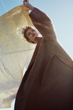 a woman is holding an umbrella in her hand