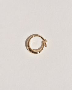 A semi-permanent style, the Sempre Hoop is part of a new offering of Leigh Miller that is designed to be worn everyday- or 'sempre'- which means always in Portuguese and Italian. This sculptural, solid gold hoop is intended to be put in, and never taken off. Wear it in the shower, in the pool or to sleep. Simply slide it in and fold the arm into its hook. Leigh was inspired to design this series to be the perfect huggers to compliment the rest of our sculptural earrings. The Sempre is ideal for 14k Gold Hoop Jewelry Si Clarity, 14k Gold Halo Huggie Earrings, 14k Gold Round Halo Huggie Earrings, Gold 14k Huggie Earrings With Halo, 14k Gold Round Huggie Earrings With Halo, 14k Gold Halo Hoop Earrings, Minimalist Hoop Earrings With Halo, Classic Gold Huggie Earrings With Halo, Minimalist Hoop Jewelry With Halo