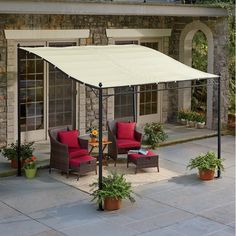 an outdoor patio with furniture and a canopy