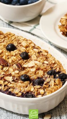 blueberry baked oatmeal in a white dish on a table with plates