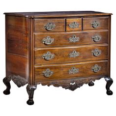 an antique chest of drawers with ornate carvings on the front and sides, in dark wood