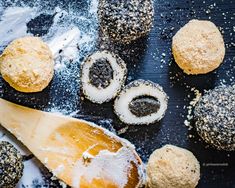 several different types of pastries on a table with a wooden spatula and spoon