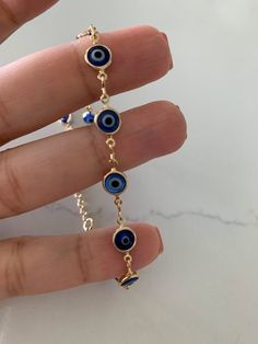 "7MM 18k Gold Filled Evil Eye Figaro Anklet *Layering Gold Anklet*18K Gold Filled Chain* Figaro Anklet* Figaro Chain * Everyday Anklet * Body Jewelry * Blue Eye Figaro Anklet This beautiful 18K gold filled anklet can be worn on its own or as a layering piece to add a statement to your outfit. It comes available in 18K gold filled in gold color only. ♦ Materials: 18K Gold filled ♦ Available colors: Gold ♦ Necklace measurements: 9''or 9\" +1.5\" extender 7mm in width ♦ Pendant measurements: 6mm wi Evil Eye Anklet, Necklace Measurements, Gold Anklet, Jewelry Blue, Figaro Chain, Blue Eye, Ankle Bones, Anklet Jewelry, Body Jewellery