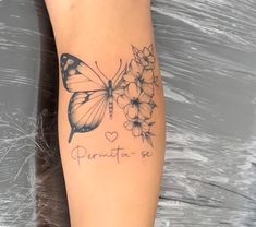 a woman's arm with a butterfly and flowers tattoo on the left side of her leg